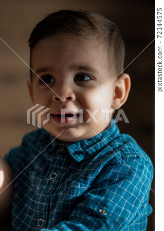 Childhood, family, loneliness concepts - Little preschool black boy in blue clothes Persian Arab appearance of two years of mixed nationality sitting on soft light bed with pacifier in mouth at home Childhood, family, loneliness concepts - Little preschool black boy in blue clothes Persian Arab appearance of two years of mixed nationality sitting on soft light bed with pacifier in mouth at home 72144575