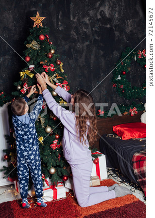 Mom and boy decorates Christmas tree Christmas New Year Mom and boy decorates Christmas tree Christmas New Year 72145672