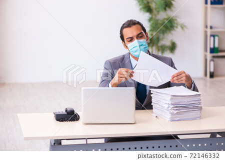 Young male employee wearing mask during pandemic 72146332