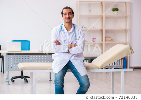 Young male doctor working in the clinic 72146333