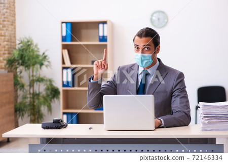 Young male employee wearing mask during pandemic Young male employee wearing mask during pandemic 72146334