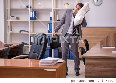 Young male employee sleeping at workplace Young male employee sleeping at workplace 72146449