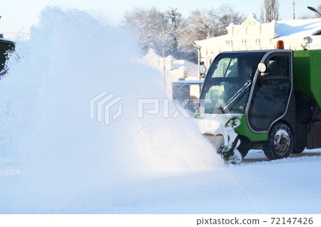 Special snow machine clears snow on the city street 72147426