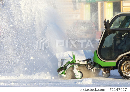 street cleaning the city from snow with the help of special equipment mini. 72147427