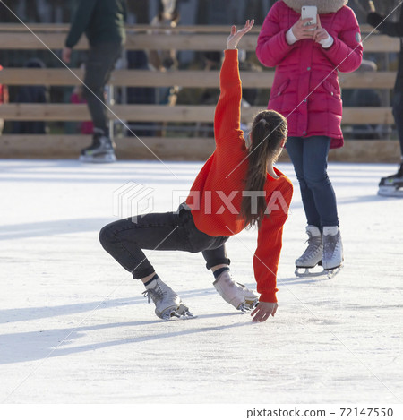 girl is photographed on an ice skating rink. Hobbies and winter vacations girl is photographed on an ice skating rink. Hobbies and winter vacations 72147550