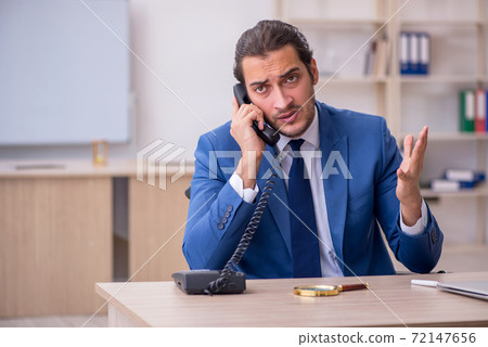 Young male employee in wheel-chair working in the office Young male employee in wheel-chair working in the office 72147656