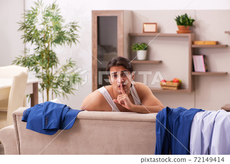 Young male employee getting up late at home 72149414