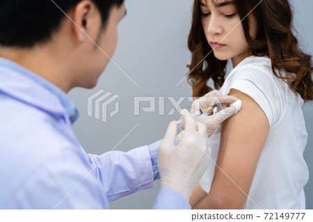 doctor holding syringe and using cotton before make injection to patient. Covid-19 or coronavirus vaccine 72149777
