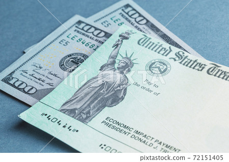 A US stimulus check on with some one-hundred-dollar bills 72151405