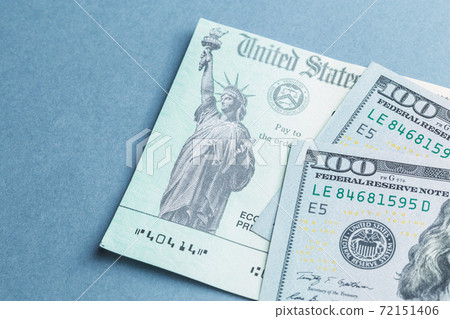 A US stimulus check on with some one-hundred-dollar bills A US stimulus check on with some one-hundred-dollar bills 72151406