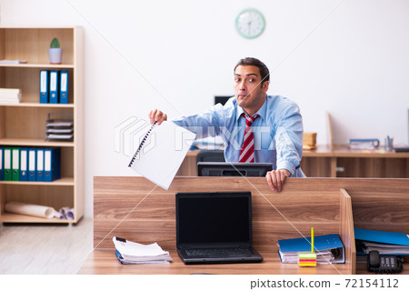 Young male employee in industrial espionage concept 72154112