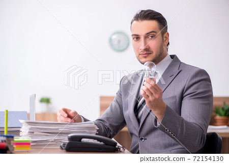 Young male employee working in the office 72154130