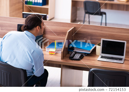 Young male employee in industrial espionage concept Young male employee in industrial espionage concept 72154153