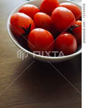 Fresh organic vegetable cherry tomatoes in a porcelain plate 72154416