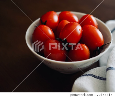 Fresh organic vegetable cherry tomatoes in a porcelain plate 72154417