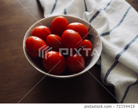 Fresh organic vegetable cherry tomatoes in a porcelain plate 72154418