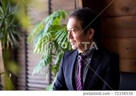 Businessman sitting at the desk Businessman sitting at the desk 72156538