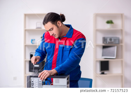 Young male repairman repairing computer Young male repairman repairing computer 72157523