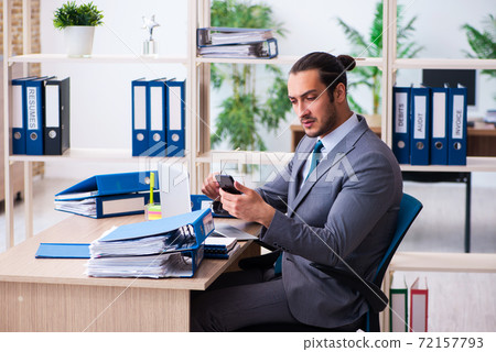 Young male employee and too much work in the office Young male employee and too much work in the office 72157793