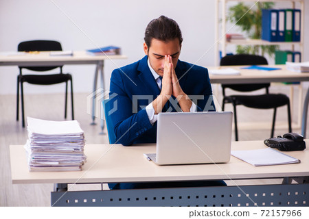 Young male employee working in the office 72157966