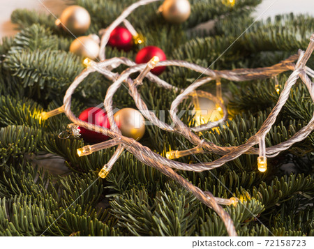 Christmas spruce branches with decor lights 72158723