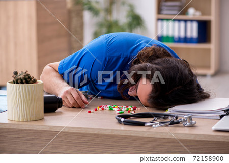 Young male doctor committing suicide in the hospital Young male doctor committing suicide in the hospital 72158900