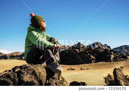 Adult caucasian woman in healthy trekking outdoor sport and leisure activity - young female sit down on the rocks and enjoy and rest in a mountain free scenic place Adult caucasian woman in healthy trekking outdoor sport and leisure activity - young female sit down on the rocks and enjoy and rest in a mountain free scenic place 72159178
