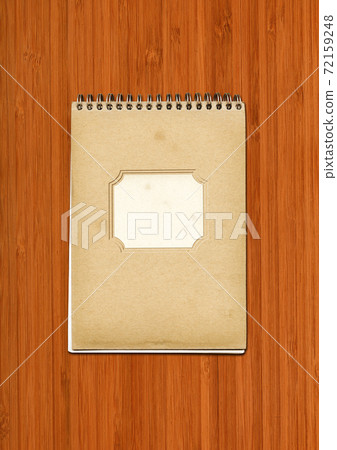 Vintage spiral close notebook on dark wooden background Vintage spiral close notebook on dark wooden background 72159248