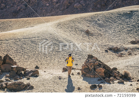 Wild hiking outdoor activity in the mountain and desert scenic landscape - caucasian professional adventurer man walk and discover beautiful places - el teide vulcan tenerife tourism active people Wild hiking outdoor activity in the mountain and desert scenic landscape - caucasian professional adventurer man walk and discover beautiful places - el teide vulcan tenerife tourism active people 72159399