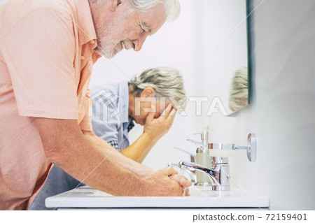 Hygiene and disinfect corona virus at home washing and cleaning hands together - old people use water in the bathroom for health lifestyle during covid-19 emergency Hygiene and disinfect corona virus at home washing and cleaning hands together - old people use water in the bathroom for health lifestyle during covid-19 emergency 72159401