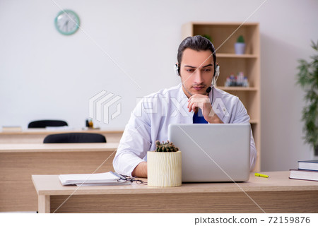 Young male doctor in telemedicine concept Young male doctor in telemedicine concept 72159876