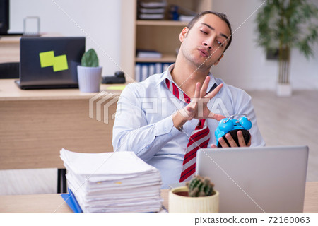 Young male employee in time management concept 72160063