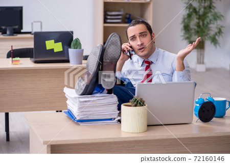 Young male employee in time management concept 72160146