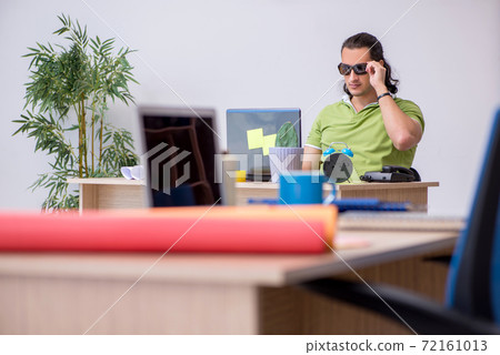 Young male designer working in the office 72161013
