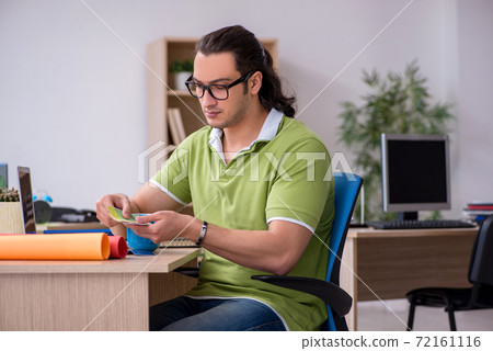 Young male designer working in the office Young male designer working in the office 72161116