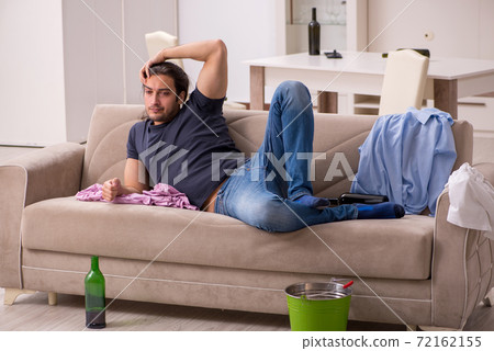 Young unemployed man drinking alcohol at home Young unemployed man drinking alcohol at home 72162155