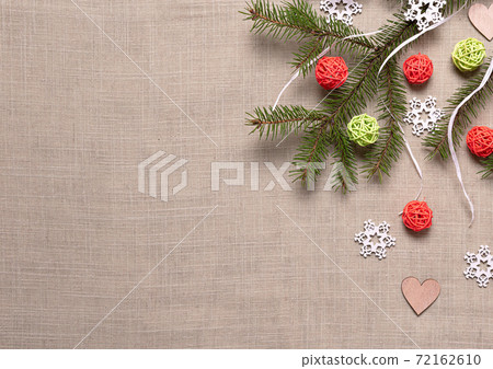 Fir branch, snowflakes, balls and hearts on beige 72162610
