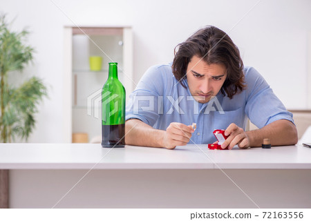 Young male alcoholic in unrequited love concept Young male alcoholic in unrequited love concept 72163556