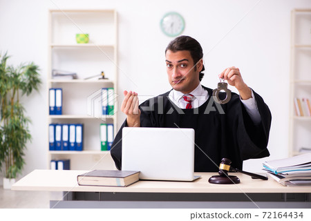 Young male lawyer working in the courthouse Young male lawyer working in the courthouse 72164434