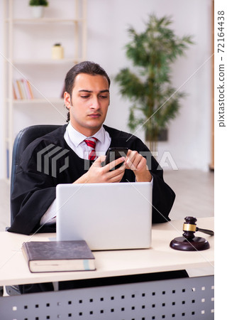 Young male lawyer working in the courthouse 72164438