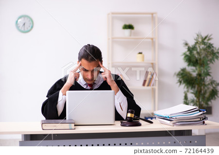Young male lawyer working in the courthouse Young male lawyer working in the courthouse 72164439