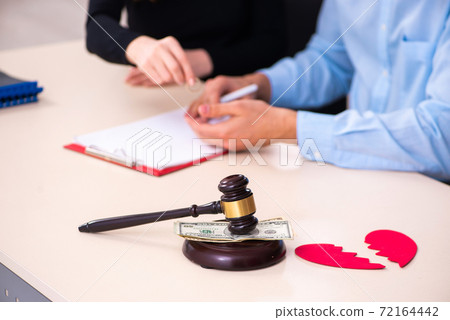 Young couple divorcing in alimony concept Young couple divorcing in alimony concept 72164442