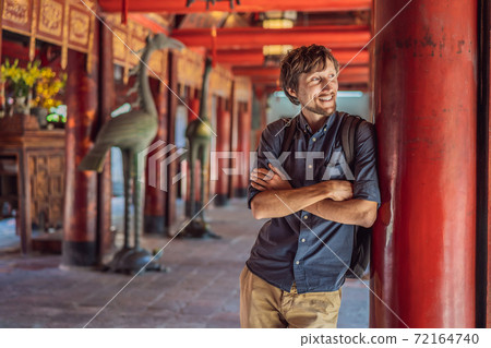 Man tourist in Temple of Literature in Hanoi in Southeast Asia, Vietnam. Temple of Confucius in Vietnamese capital. Vietnam reopens after coronavirus quarantine COVID 19 Man tourist in Temple of Literature in Hanoi in Southeast Asia, Vietnam. Temple of Confucius in Vietnamese capital. Vietnam reopens after coronavirus quarantine COVID 19 72164740