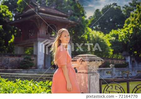 Woman tourist in Temple of Literature in Hanoi in Southeast Asia, Vietnam. Temple of Confucius in Vietnamese capital. Vietnam reopens after coronavirus quarantine COVID 19 72164770