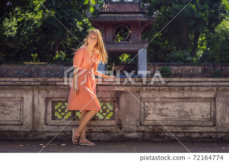 Woman tourist in Temple of Literature in Hanoi in Southeast Asia, Vietnam. Temple of Confucius in Vietnamese capital. Vietnam reopens after coronavirus quarantine COVID 19 Woman tourist in Temple of Literature in Hanoi in Southeast Asia, Vietnam. Temple of Confucius in Vietnamese capital. Vietnam reopens after coronavirus quarantine COVID 19 72164774