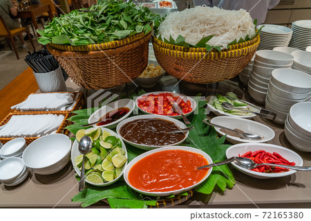 Traditional Vietnamese Pho noodle soup and seasoning in buffet counter 72165380