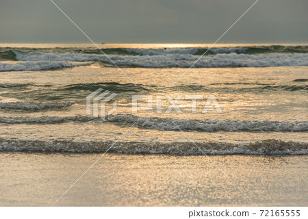 Scenery of soft waves on the beach at late evening Scenery of soft waves on the beach at late evening 72165555