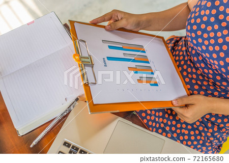 Top view photo of businesswoman reading sales statistics data document Top view photo of businesswoman reading sales statistics data document 72165680
