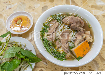 Bowl of delicious Vietnamese beef bone noodles soup  72165693