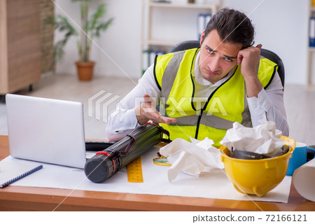 Young male architect working in the office Young male architect working in the office 72166121